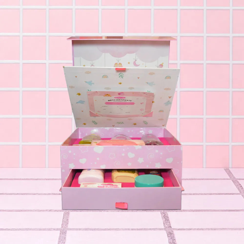 Mothercare Signature Box Includes Mothercare's Baby Care Range, All Center Placed on a Tile like Background in Pink Color